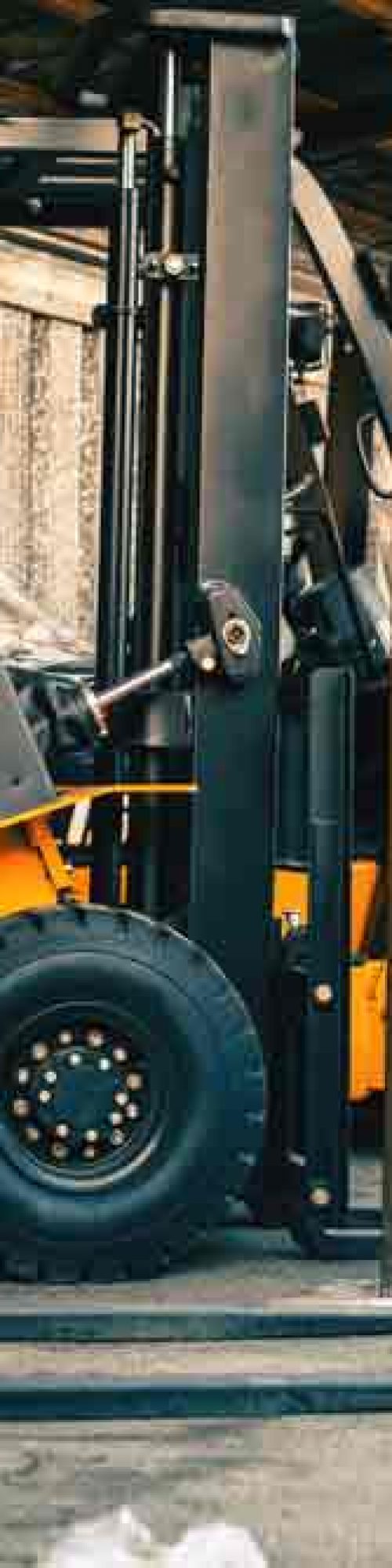 Multiple Forklifts Parked In A Warehouse